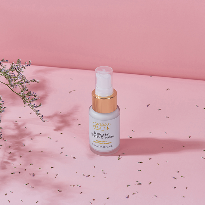 Brightening Vitamin C Serum 30ml on a pink surface with soft shadows, for sensitive, eczema-prone, and autoimmune skin.