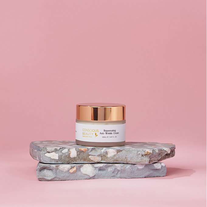 Rejuvenating Anti-Wrinkle Cream 50ml placed on stacked stone against a pink background, ideal for sensitive and aging skin.