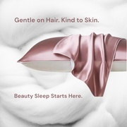 Blush pink silk pillowcase draped over pillow with soft white background