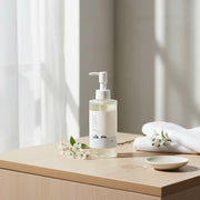 Round Lab 1025 Dokdo Cleansing Oil 200ml on wooden bathroom surface with towel and soft natural light